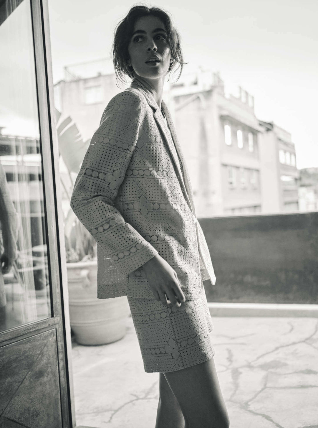Woman wearing a short set with a white shirt featuring a circular design in a black &amp; white background. Ellinor shorts by Mos Mosh at The Wardrobe