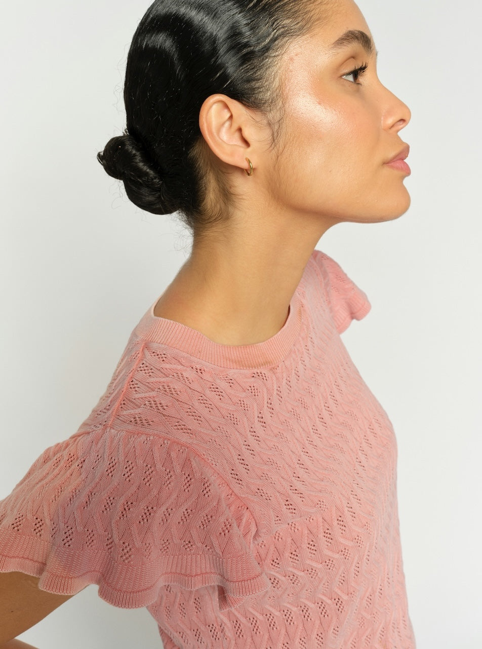 Pink patterned knit top with flutter sleeves and crew neckline