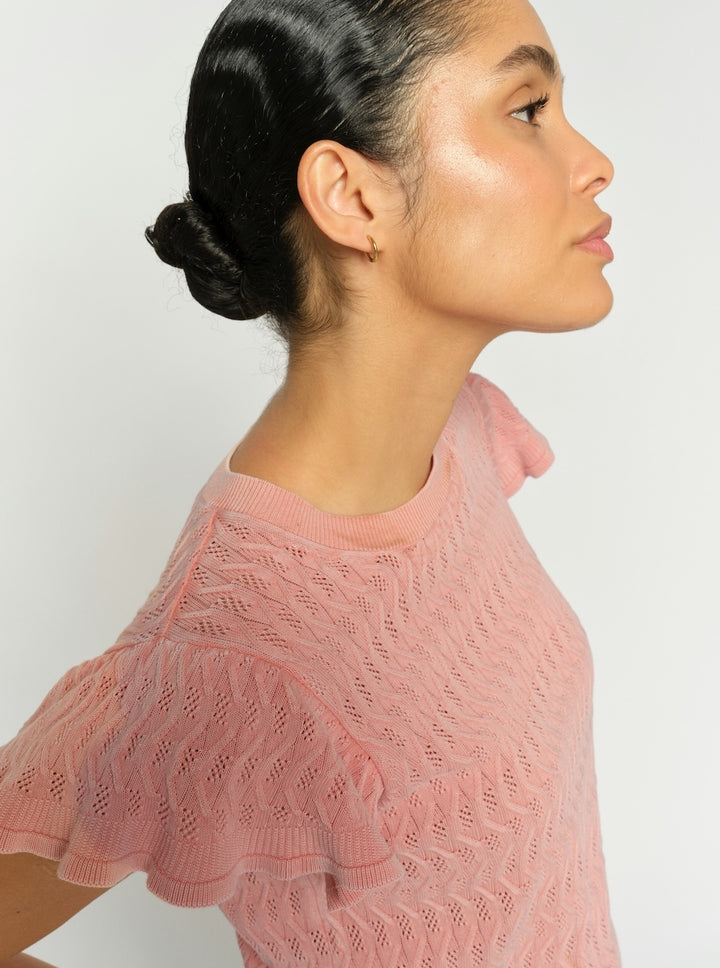 Pink patterned knit top with flutter sleeves and crew neckline