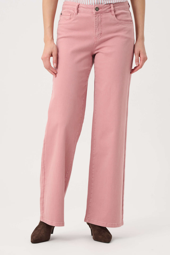 Joseph Ribkoff modeling a pink and white vertically striped button-down shirt with puffed sleeves, paired with dusty pink wide-leg pants and dark brown pointed-toe heels, against a plain light gray studio background.