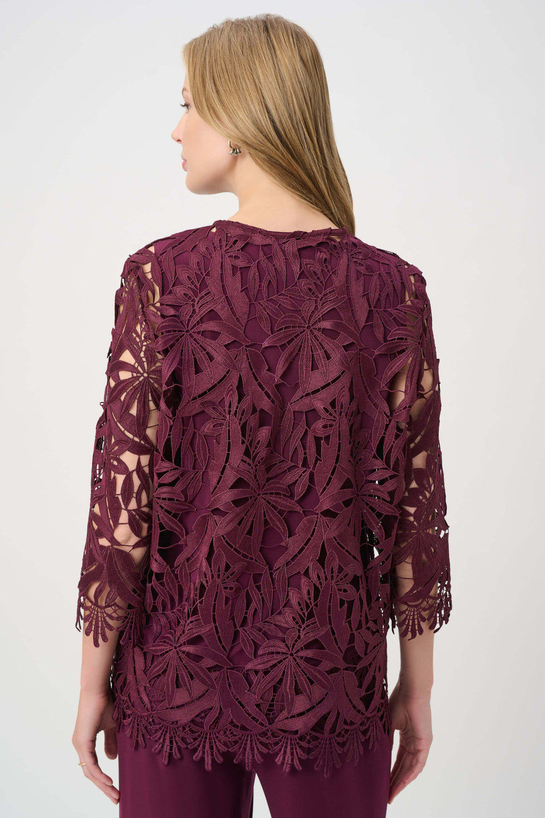 Joseph Ribkoff Model wearing a burgundy lace jacket over a matching dress on a white background back view 