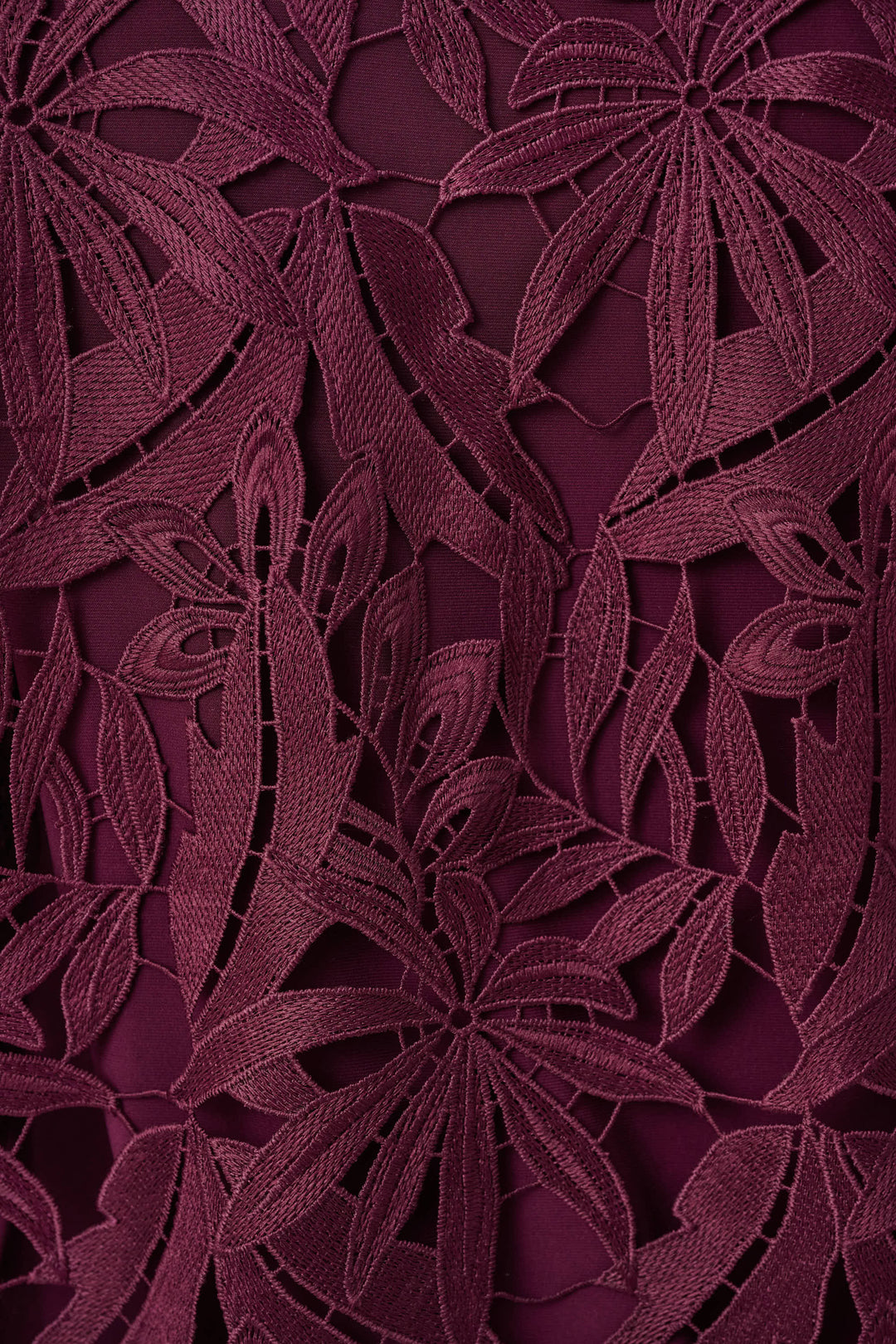 Joseph Ribkoff Close-up of a dark purple floral lace fabric pattern