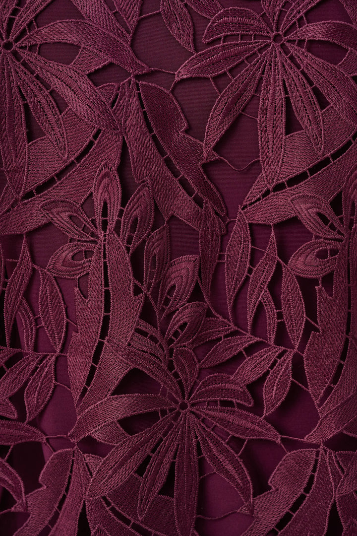 Joseph Ribkoff Close-up of a dark purple floral lace fabric pattern