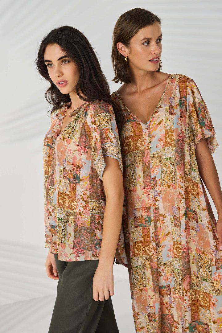 Lania The Label Two women modeling matching floral print kaftan-style tops and dresses in a studio setting with a light gray background.