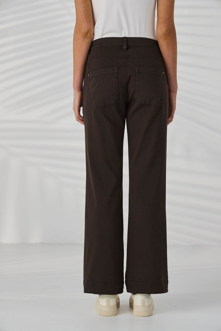 Lania The Label Model wearing dark brown pants on a white background