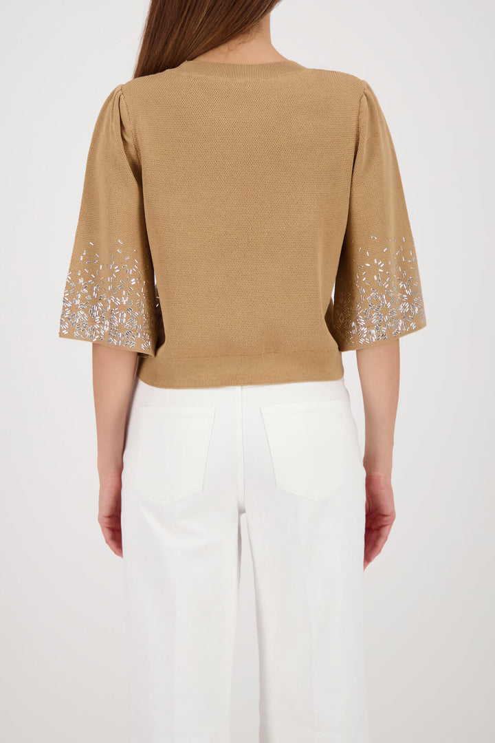 Beige knit top back view with solid knit back and jeweled speckle sleeve cuffs