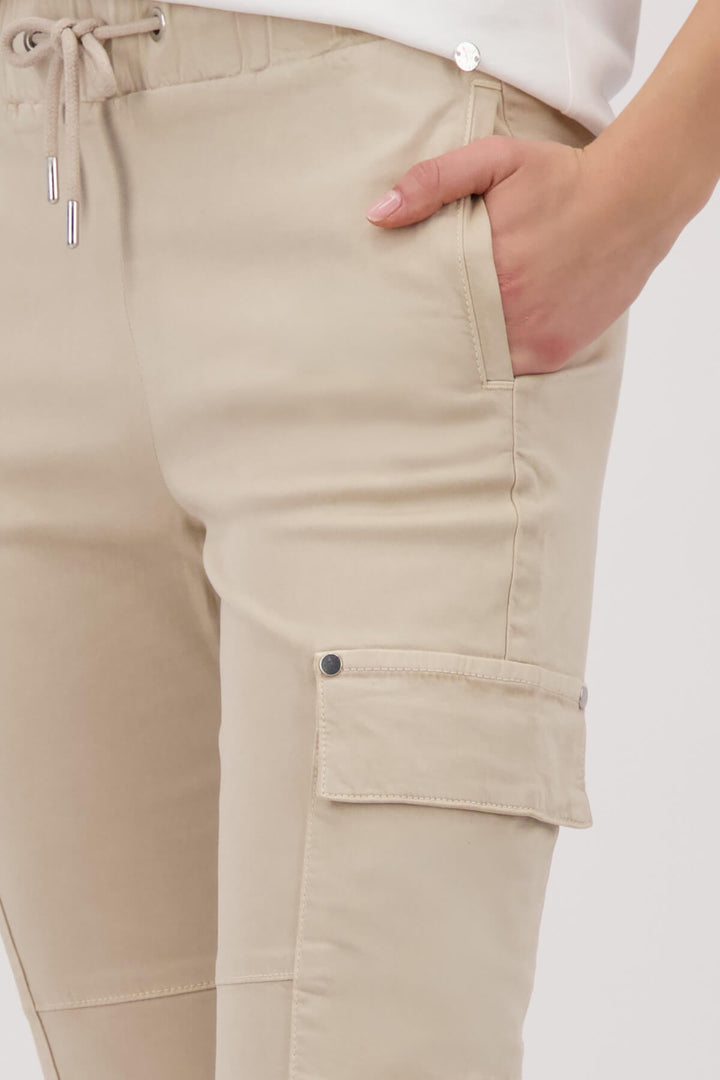 Monari sand cargo pants on model, drawstring waist with thigh cargo pockets. Top of thight shots.