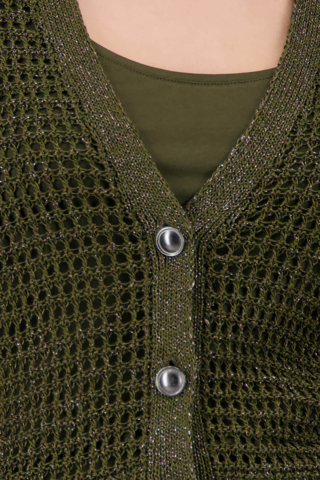 Monari woman modeling a short-sleeve olive green knit cardigan over a matching olive green top, paired with wide-leg white pants featuring a green and beige palm tree print, against a light gray studio background. Close up