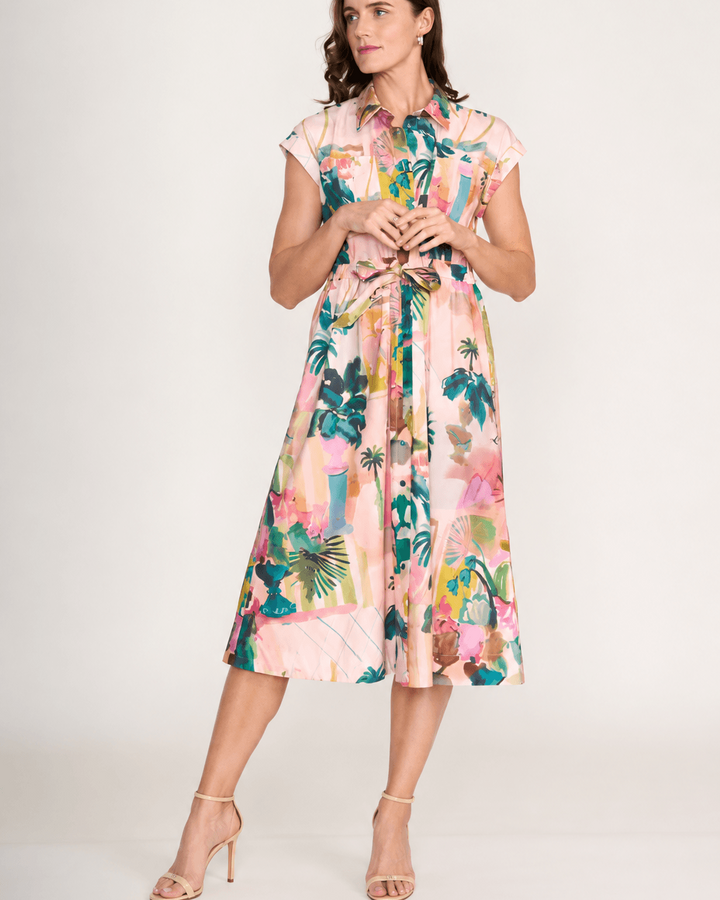 Foil clothing.A model on  a dress in Light pink,  cap-sleeve, midi length. A colourful botanical print and gathered waist. On a white background