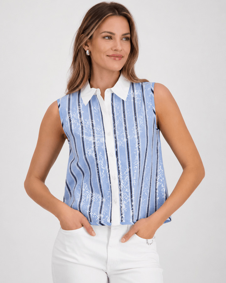 Monari woman modeling a sleeveless button-front top with vertical blue and white stripes, a white collar, and white pants against a light gray studio background.