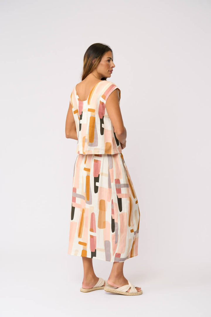 Front-3/4 abstract block-print midi skirt, cream base with peach and charcoal blocks
