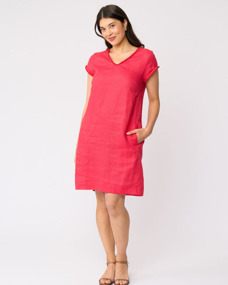 Foil clothing model in a short-sleeve V-neck linen dress in a vibrant pinkish-red color, standing against a plain white studio background.