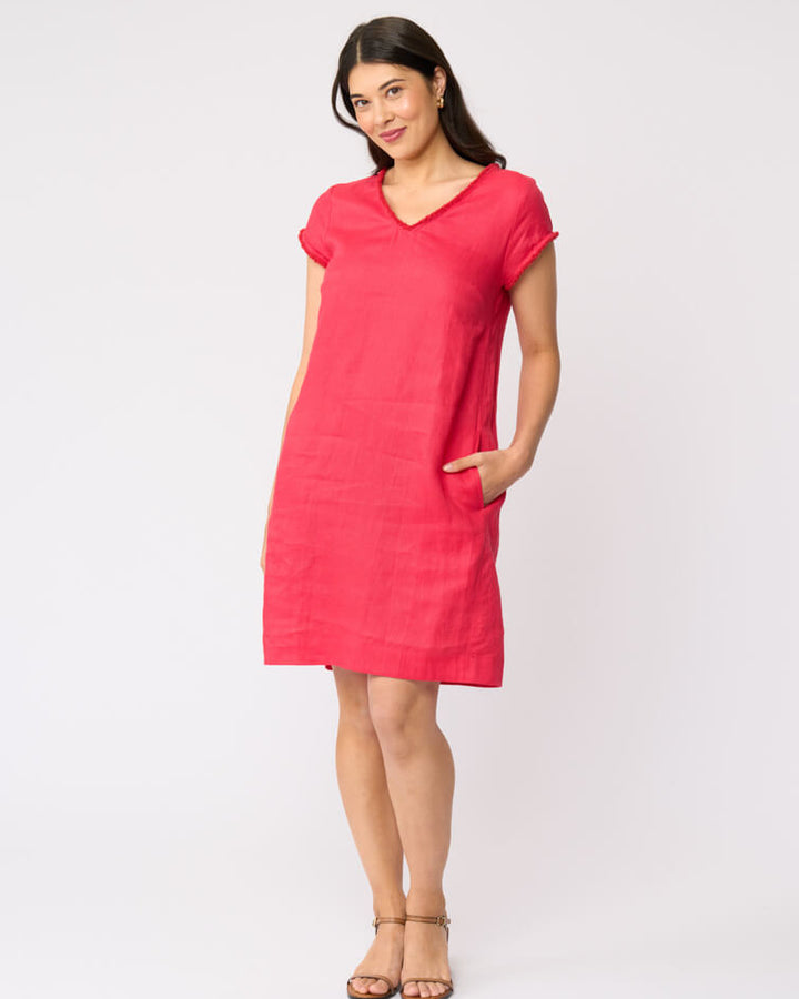 Foil clothing model in a short-sleeve V-neck linen dress in a vibrant pinkish-red color, standing against a plain white studio background.
