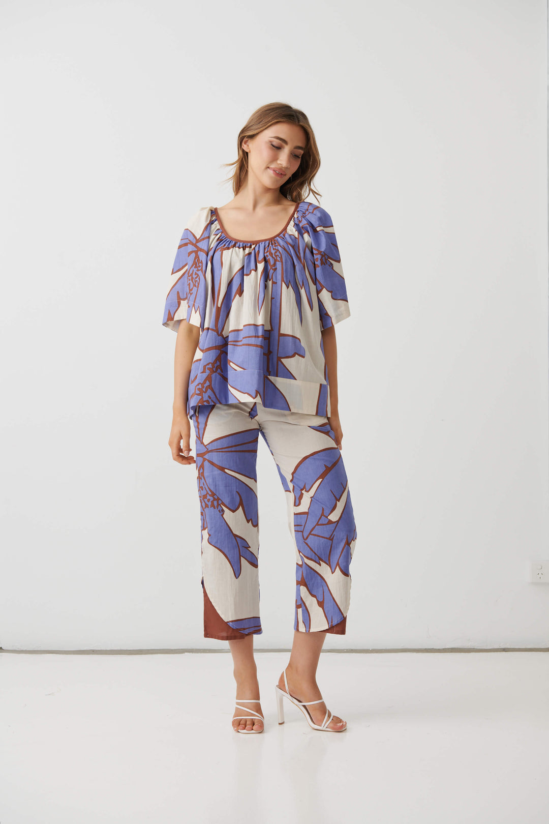 Cream mid-calf pants with lilac and blue palm print, relaxed fit