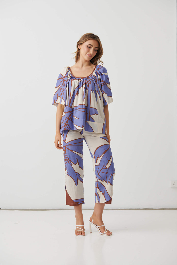 Cream mid-calf pants with lilac and blue palm print, relaxed fit