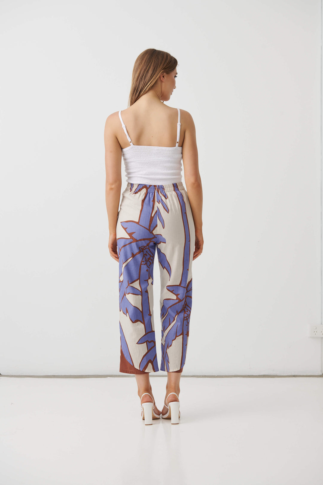 Back view: cream mid-calf pants with lilac and blue palm print