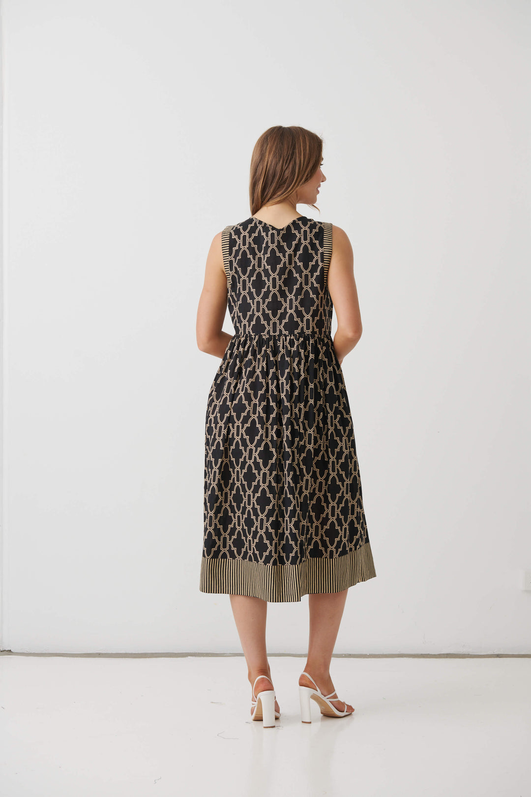 Black sleeveless midi dress with trellis pattern and scooped back