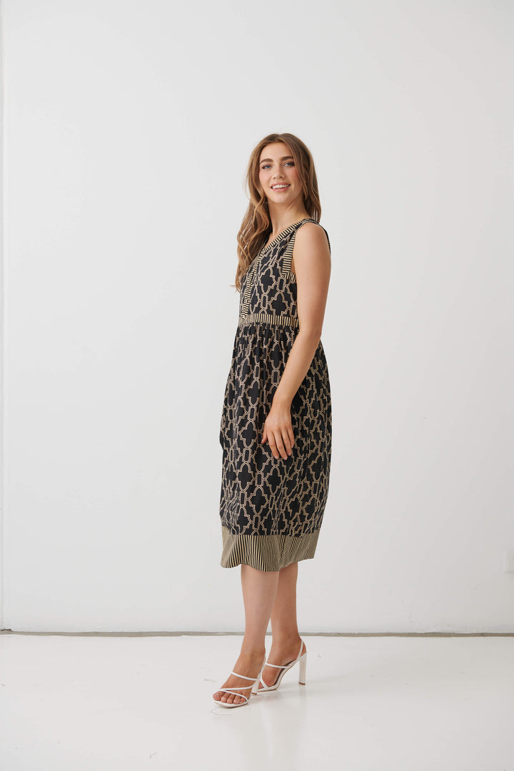 Black sleeveless midi dress with gold trellis motif and fit-and-flare skirt