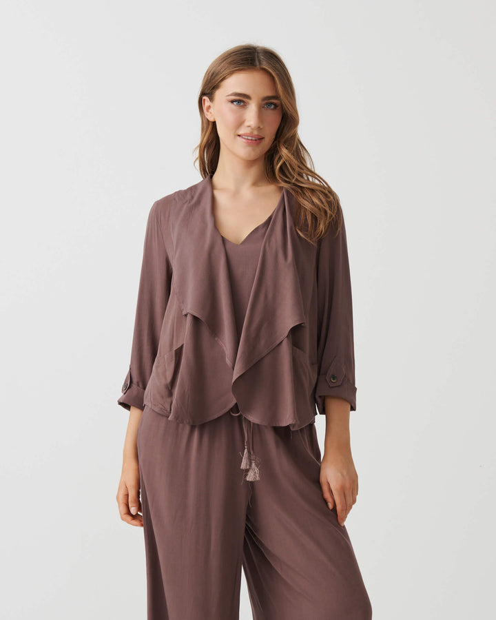 Holmes &amp; Fallon Mocha back-zip feature jacket with layered ruffle front and V-neck underlayer. On a white studio 
background
