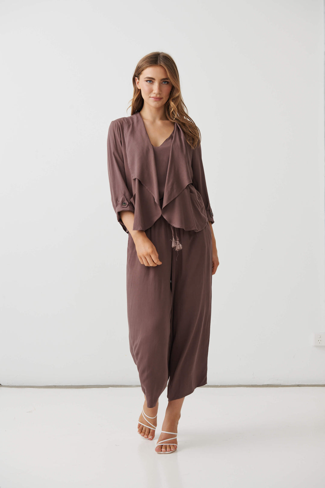 Holmes &amp; Fallon Mocha back-zip feature jacket with layered ruffle front and V-neck underlayer. On a white studio background