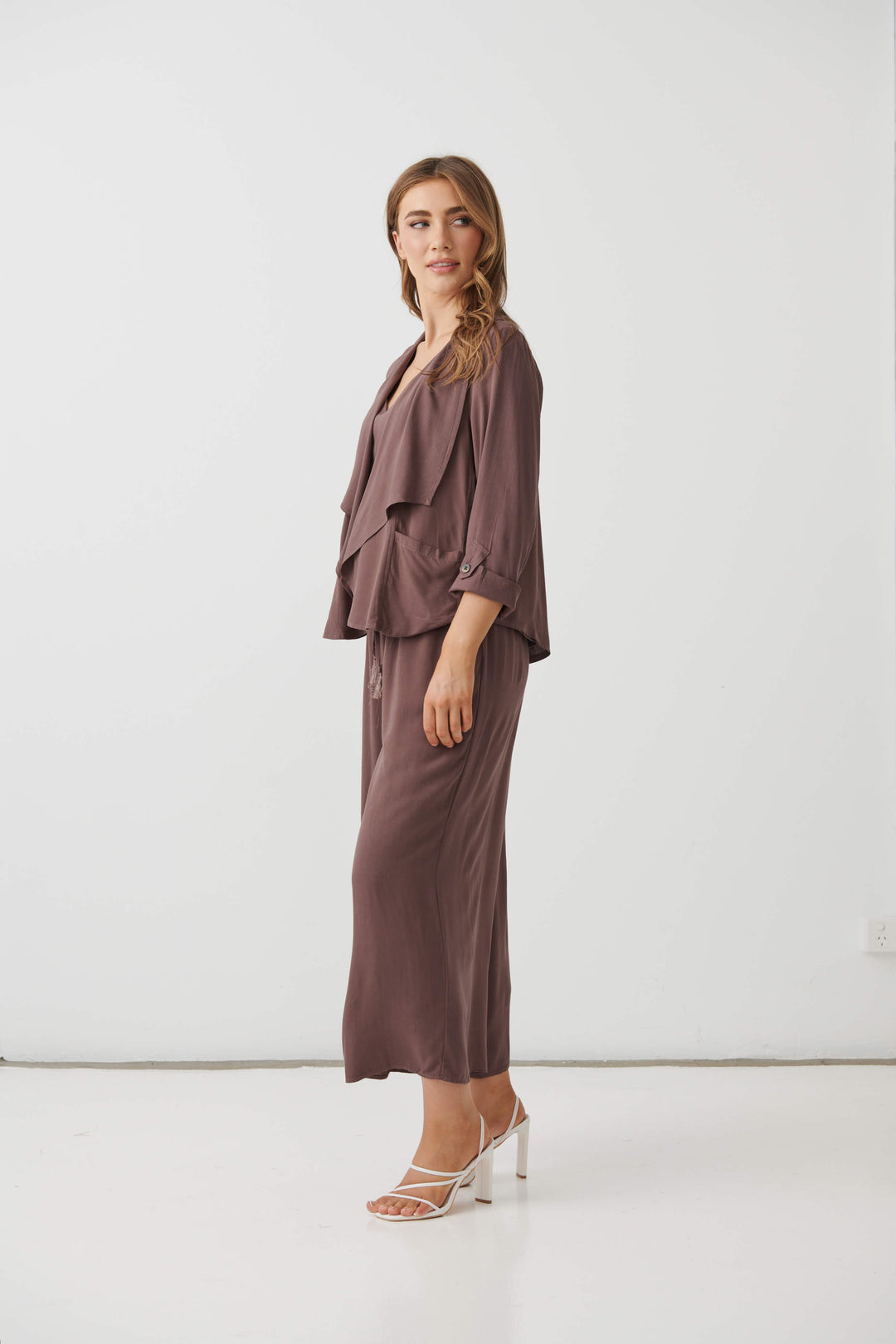 Holmes &amp; Fallon Mocha back-zip feature jacket with layered ruffle front and V-neck underlayer. On a white studio background