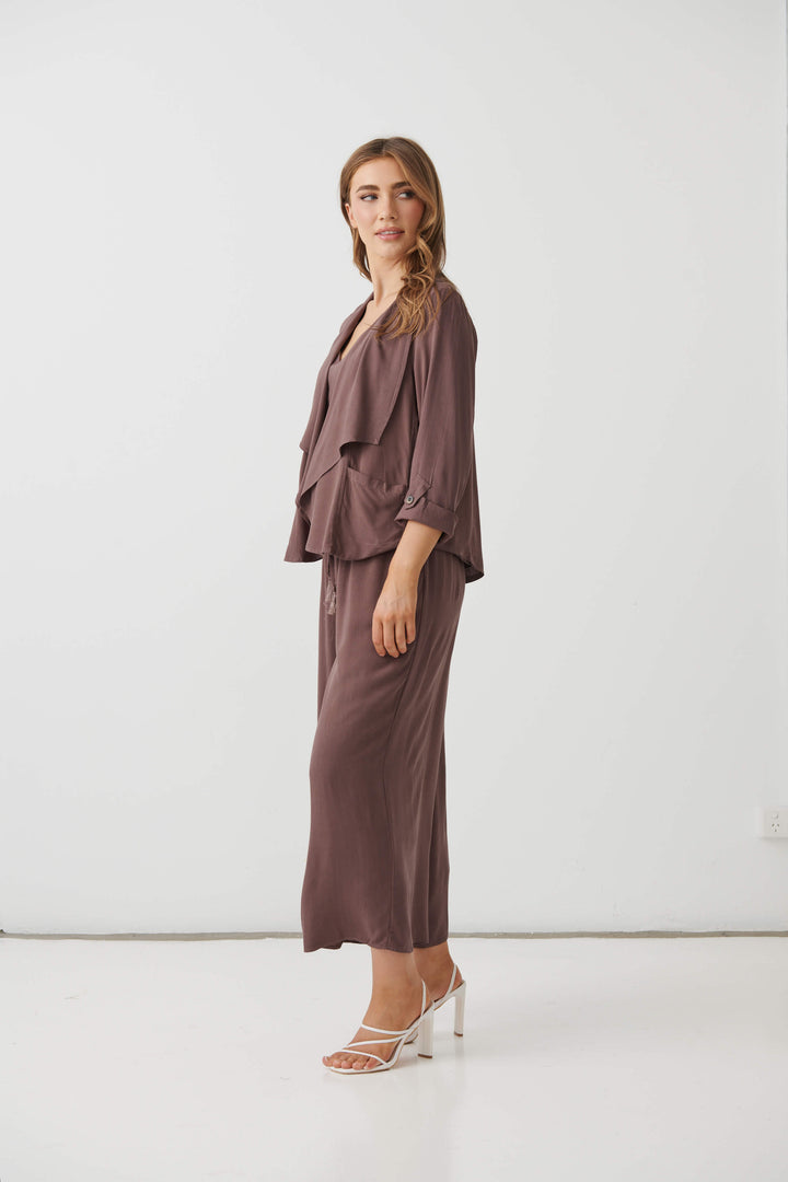 Holmes &amp; Fallon Mocha back-zip feature jacket with layered ruffle front and V-neck underlayer. On a white studio background