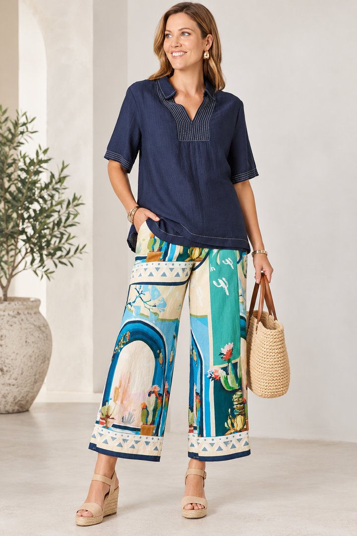 Colorful floral print wide-leg pant in blue and green with decorative border trim