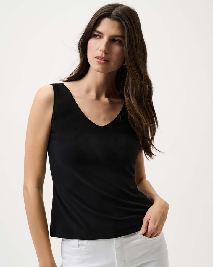 Joseph Ribkoff modelling Black V-neck sleeveless cami with smooth fitted  front. On a white background
