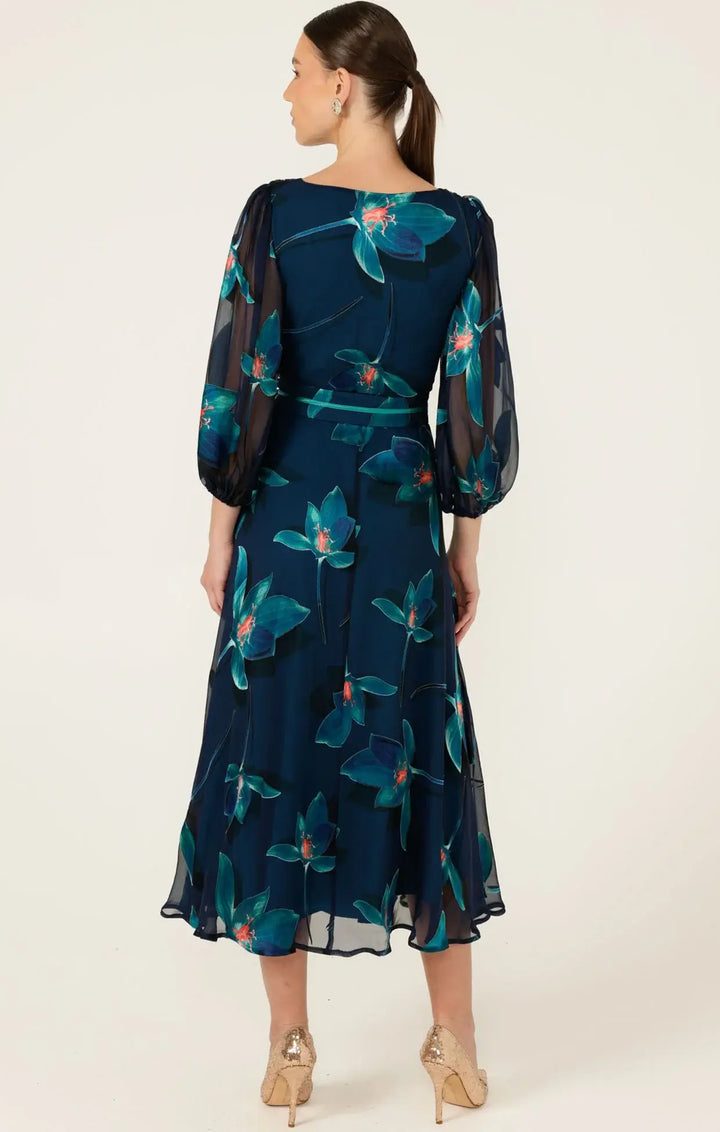 Back view: navy floral wrap midi dress with teal print, tie belt, sheer 3/4 sleeves