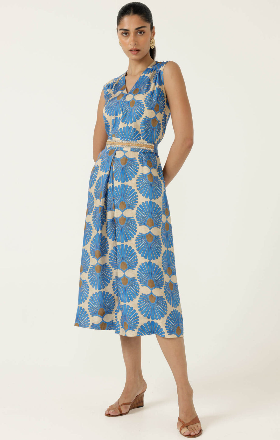 Blue sleeveless jumpsuit with V neckline, tie belt at waist, floral print wide legs