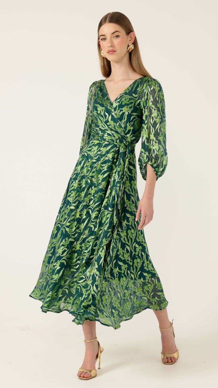 Sacha Drake Green wrap midi dress, side view, V-neck with long puff sleeves and botanical print. Modelled on a white background. 