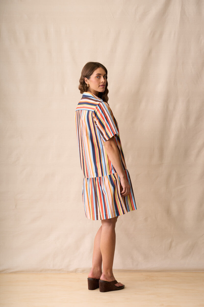 Multi-colored striped mini dress with short sleeves and tiered hem, side view