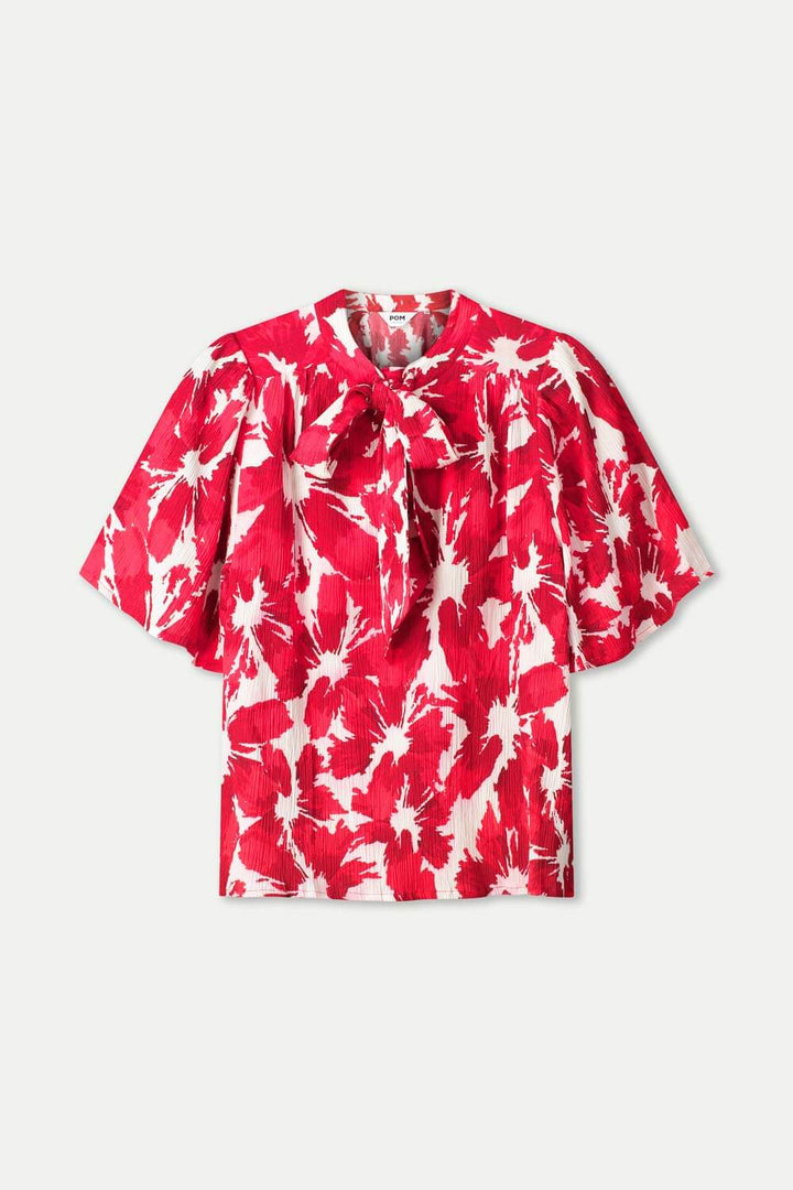 Red and white tie-dye crinkle bubble top with short sleeves and neck ties