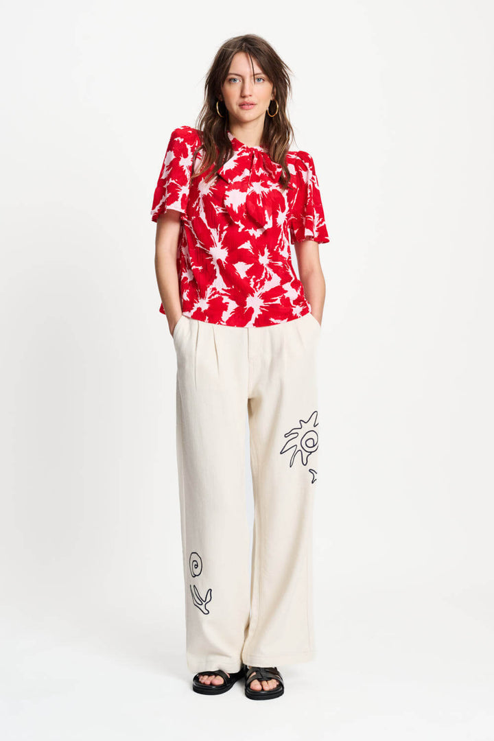 Red and white tie-dye crinkle bubble top with neck tie and short sleeves