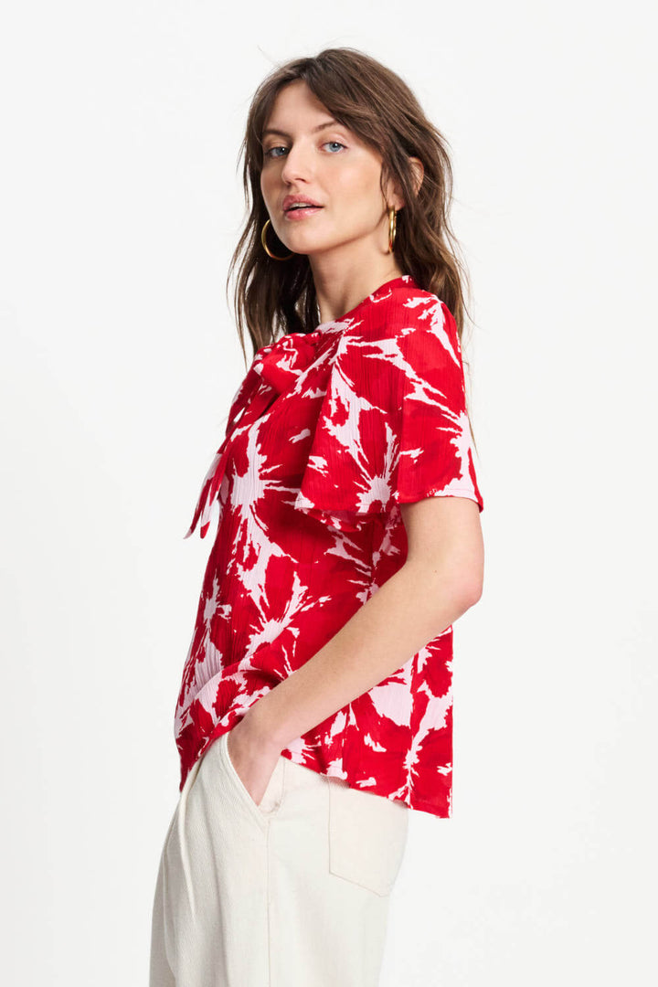 Red and white tie-dye crinkle bubble top with ruffled neckline tie, short sleeves