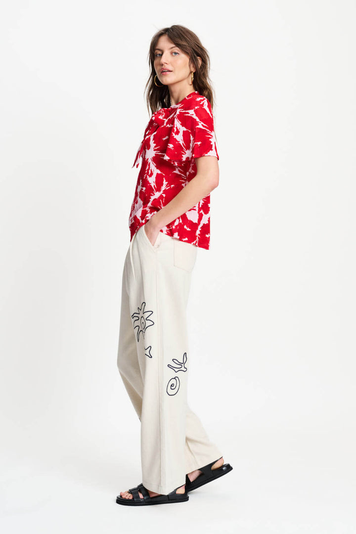 Red and white tie-dye crinkle bubble top with neck tie and short sleeves