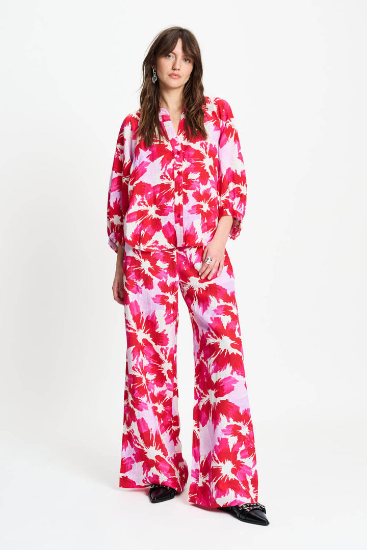 Pink and red floral wide-leg pants with elastic waist, full length.