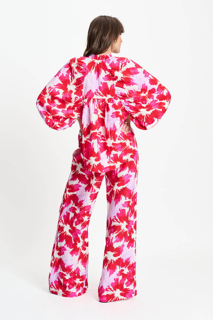 Back view of pink and white tie-dye blouse with gathered yoke and puff sleeves