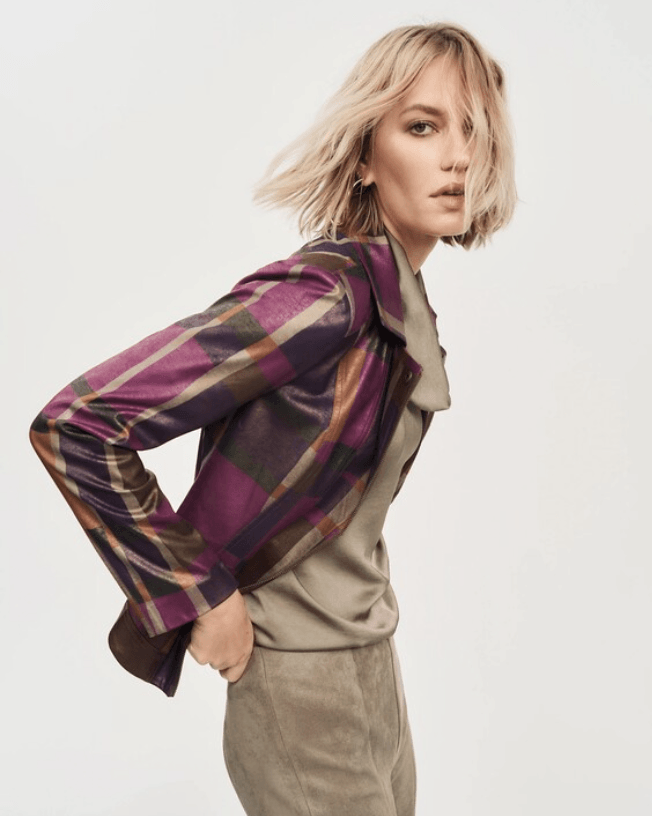 Woman wearing a plaid shirt over a beige sweater and pants on a white background by Joseph Ribkoff at The Wardrobe 