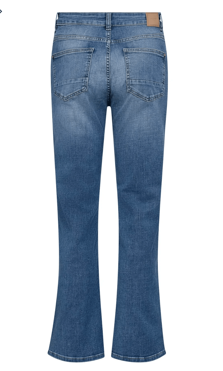 Mos Mosh model wearing medium-wash blue jeans with a blue long-sleeve button-up shirt, shown from the waist down against a light gray studio background. Flat image