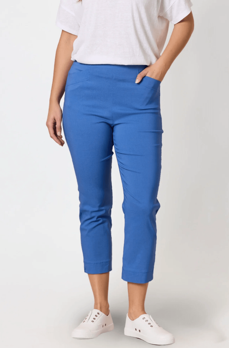 Threadz. A woman modeling a short-sleeve blue and white striped t-shirt with red trim and a red graphic print, paired with blue cropped pants and white slide sandals, against a plain white studio background.
