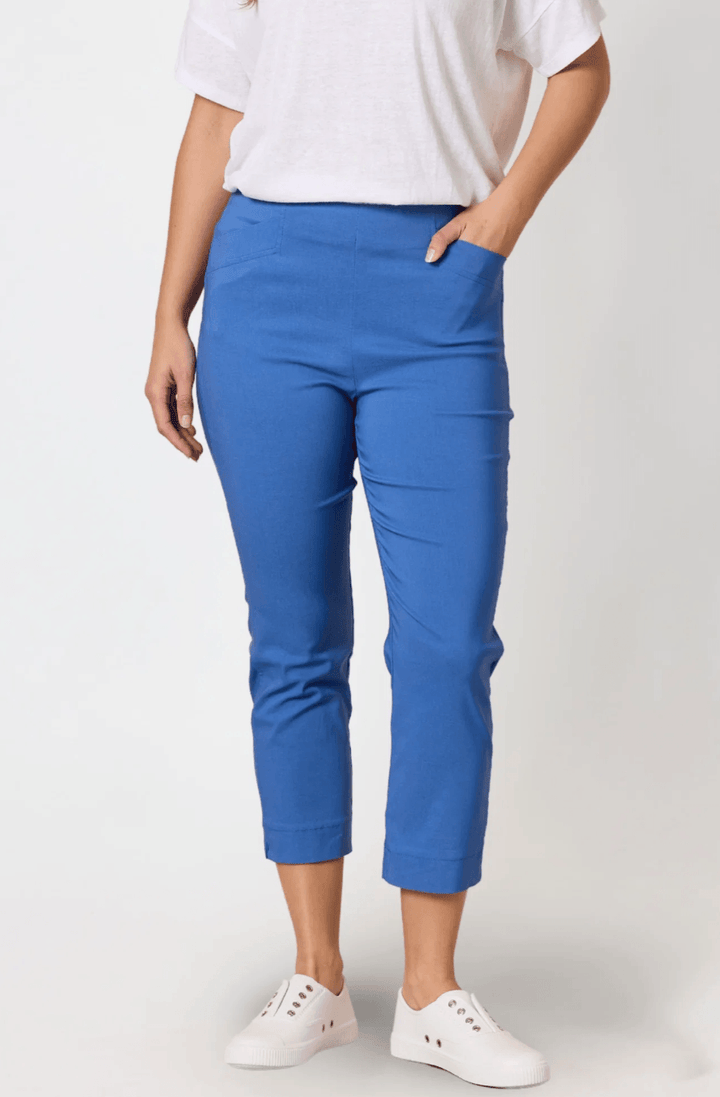 Threadz. A woman modeling a short-sleeve blue and white striped t-shirt with red trim and a red graphic print, paired with blue cropped pants and white slide sandals, against a plain white studio background.