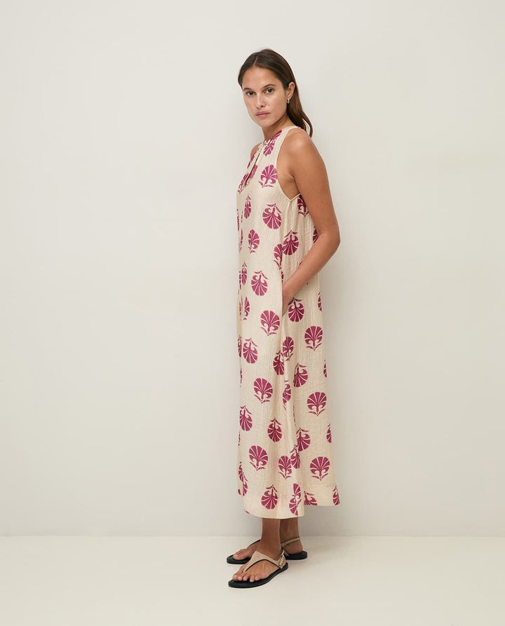 Yerse model in cream &amp; mauve maxi halter dress on a pale studio. background