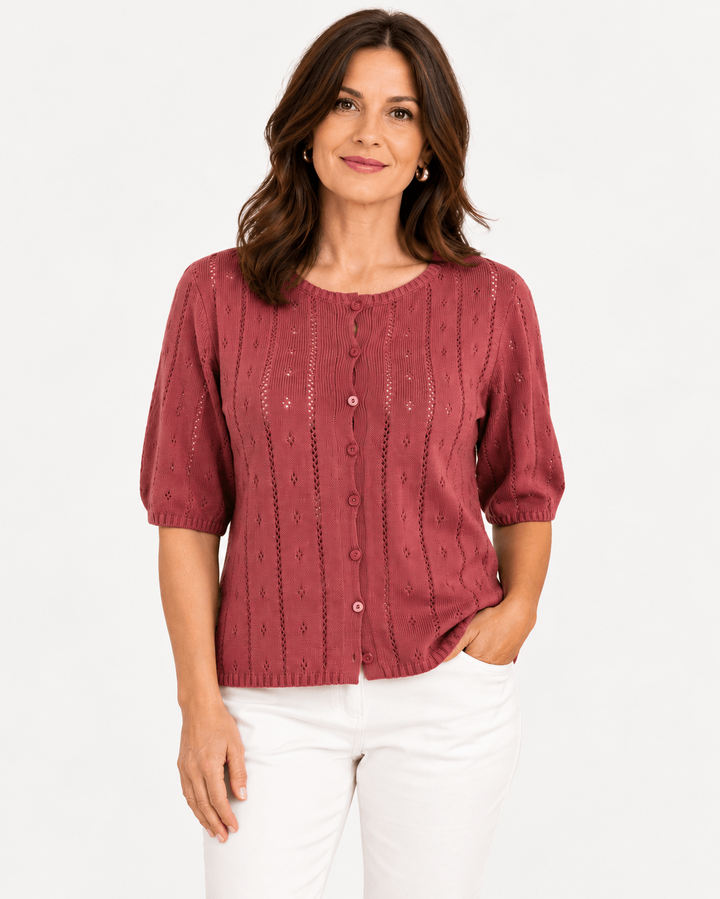 Yerse model in a short sleeve knit in dusky pink, on a white background