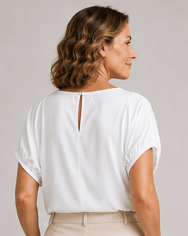 White blouse top with open back keyhole at the neckline and short puff sleeves