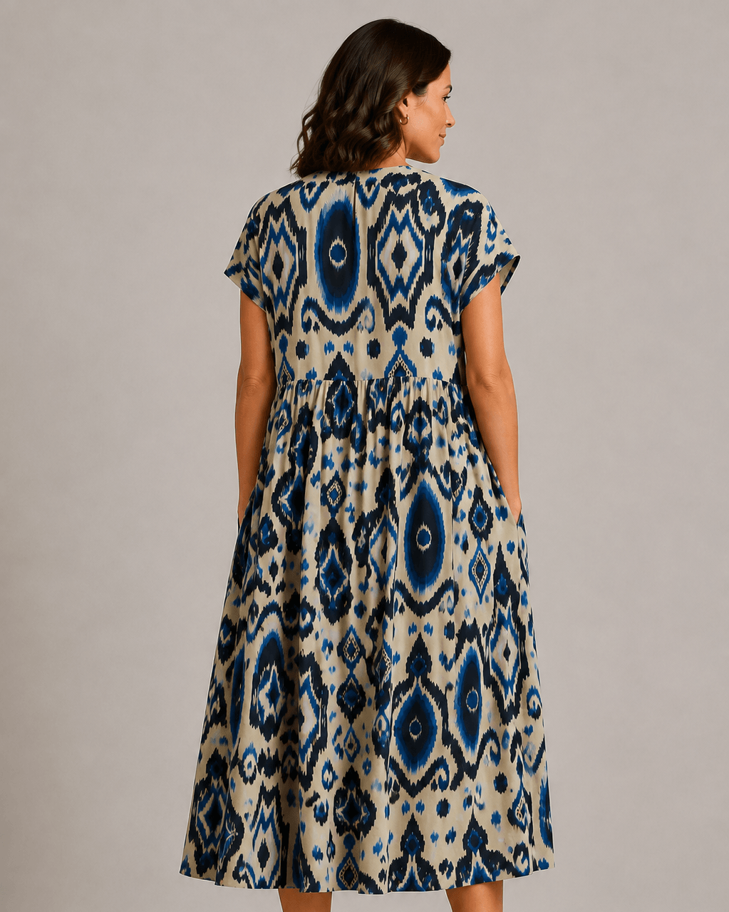 Blue-and-cream short-sleeve patterned dress, back view with tiered A-line hem