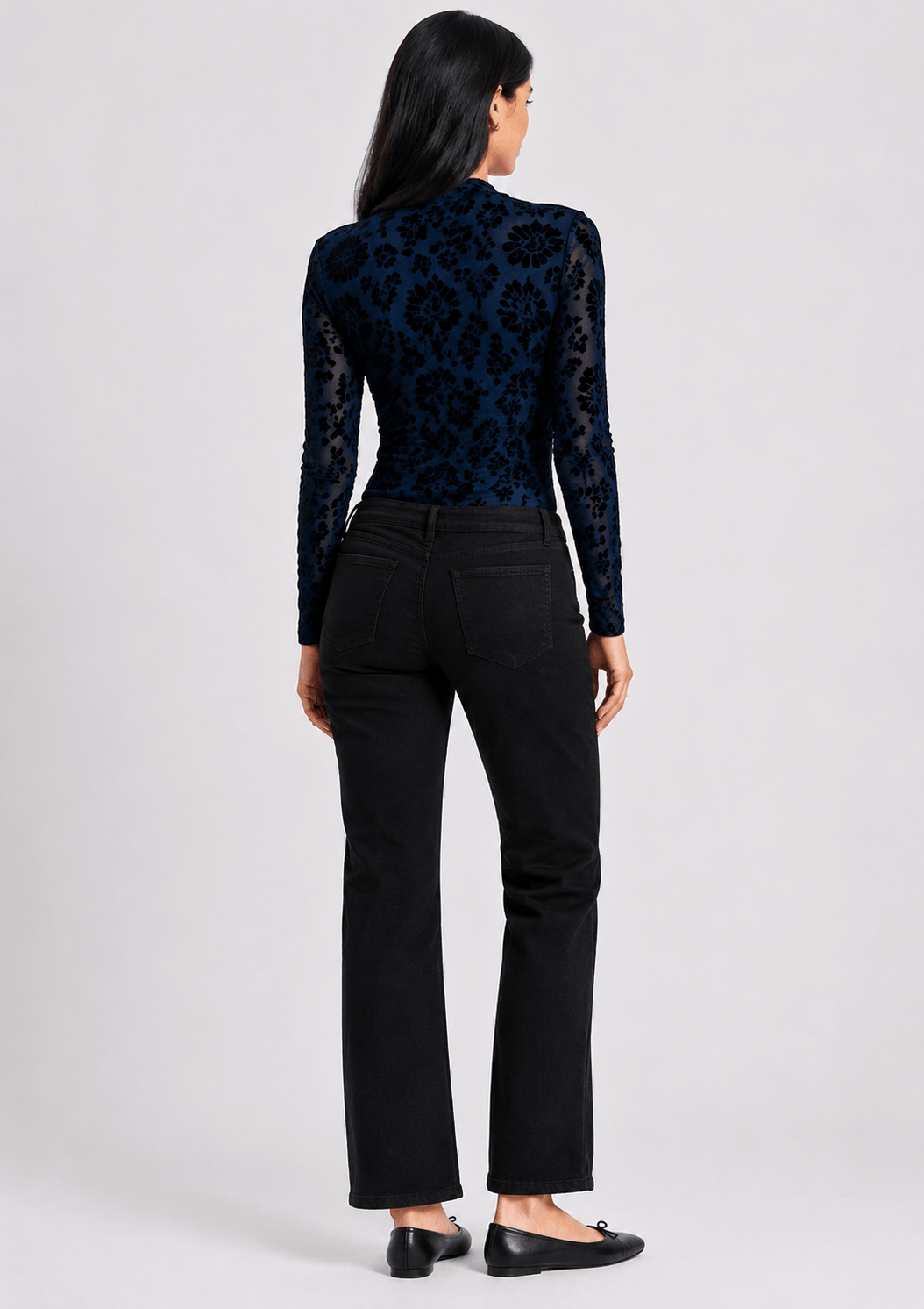 Threadz model in Vicki bootcut jeans, dark black with slight flare and front button-and-zip fly. On a white background . Back view